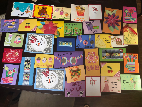 photo of lots of handmade cards sitting on a table with encouraging notes like sending love