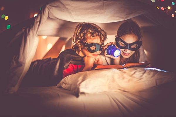 Kids Reading in a Fort with Flashlight